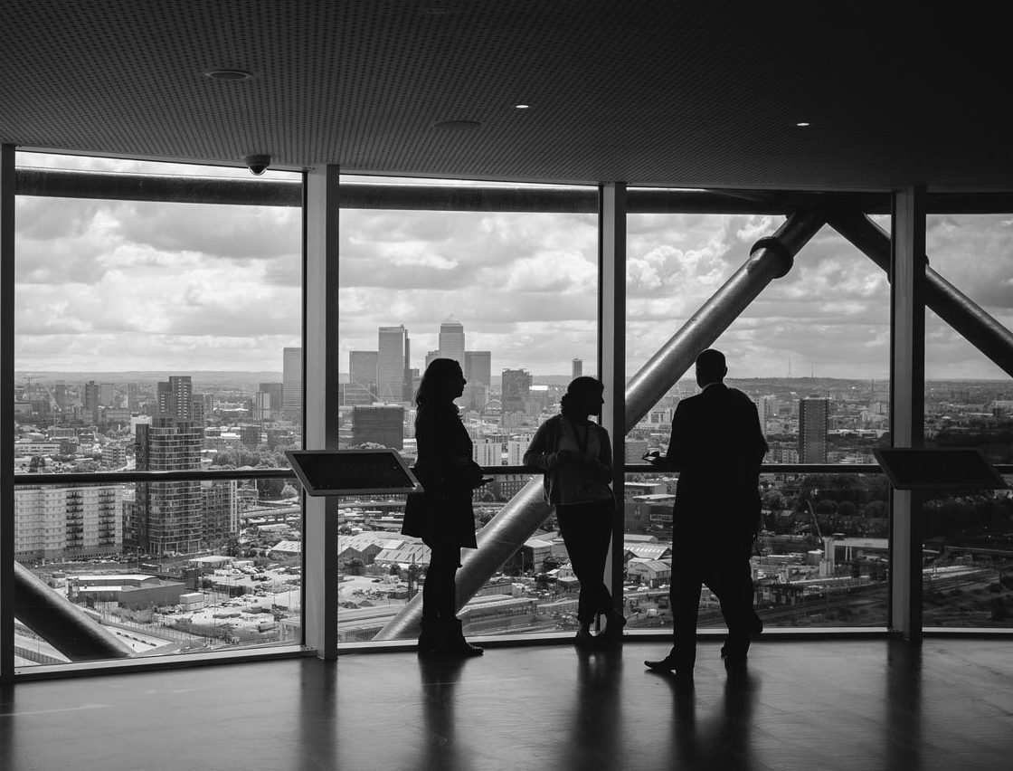 three people standing in the office